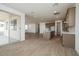 Open-concept living room with wood-look floors, modern kitchen with island, and sliding glass door at 40234 N Alegre Dr, San Tan Valley, AZ 85140