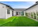 A modern backyard with newly installed green turf and well-manicured hedges at 4115 E Windsor Ave, Phoenix, AZ 85008