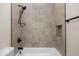 Updated bathroom featuring stone-look tile, matte fixtures, and convenient niche at 4115 E Windsor Ave, Phoenix, AZ 85008