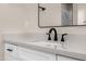 Close-up of bathroom sink with black faucet, light countertop, and shaker style cabinets at 4115 E Windsor Ave, Phoenix, AZ 85008