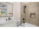 Modern bathroom features a shower over tub, modern tiling and matte black hardware at 4115 E Windsor Ave, Phoenix, AZ 85008