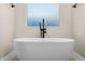 Modern bathroom with a stylish soaking tub and sleek fixtures at 4115 E Windsor Ave, Phoenix, AZ 85008