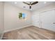 Bright bedroom features hardwood floors, a ceiling fan and a large closet for optimal storage at 4115 E Windsor Ave, Phoenix, AZ 85008