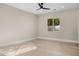 Bright, airy bedroom with hardwood floors, modern ceiling fan, and view to the exterior at 4115 E Windsor Ave, Phoenix, AZ 85008