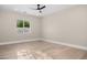 Modern bedroom with hardwood floors, ceiling fan, and a view of the serene backyard at 4115 E Windsor Ave, Phoenix, AZ 85008