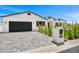 Beautiful house features gray pavers, a lush lawn and black trim with a two car garage at 4115 E Windsor Ave, Phoenix, AZ 85008