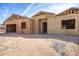 New home construction featuring wood framing, and a spacious two-car garage under a blue, partly cloudy sky at 4115 E Windsor Ave, Phoenix, AZ 85008
