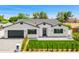 Beautiful home boasts a manicured lawn, gray driveway pavers, and striking black accents at 4115 E Windsor Ave, Phoenix, AZ 85008