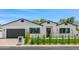 Charming single-story home with white brick, black trim, manicured lawn, and tasteful landscaping at 4115 E Windsor Ave, Phoenix, AZ 85008