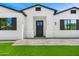 Charming house featuring gray pavers, lush grass, and black trim with a stylish front door at 4115 E Windsor Ave, Phoenix, AZ 85008