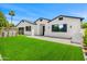 Charming home with a lush green lawn, stylish black shutters, and a well-manicured landscape at 4115 E Windsor Ave, Phoenix, AZ 85008