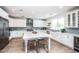 Spacious kitchen boasts white cabinets, subway tile backsplash, and large island at 4115 E Windsor Ave, Phoenix, AZ 85008