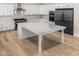 Bright kitchen featuring a large island, stainless steel appliances, and hardwood floors at 4115 E Windsor Ave, Phoenix, AZ 85008