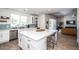 Open kitchen features stainless appliances, white cabinetry, and an island with seating at 4115 E Windsor Ave, Phoenix, AZ 85008