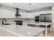 Modern kitchen featuring white cabinets, stainless steel appliances, large island, and stylish backsplash at 4115 E Windsor Ave, Phoenix, AZ 85008