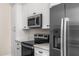 Modern kitchen with stainless steel appliances and clean white cabinets at 4115 E Windsor Ave, Phoenix, AZ 85008