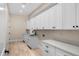Spacious laundry room featuring ample cabinetry, modern countertops, and a stainless steel sink at 4115 E Windsor Ave, Phoenix, AZ 85008