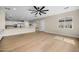 Open-concept living room with modern lighting, hardwood floors, and seamless flow to the kitchen at 4115 E Windsor Ave, Phoenix, AZ 85008