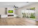 Open living room boasts hardwood floors, fireplace, built-in cabinets, and sliding glass doors to the backyard at 4115 E Windsor Ave, Phoenix, AZ 85008