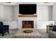 Cozy living room featuring a fireplace, built-in cabinets, and comfortable seating at 4115 E Windsor Ave, Phoenix, AZ 85008