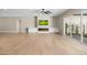 Spacious living room featuring hardwood floors, a fireplace, built-in cabinets, and large sliding glass doors at 4115 E Windsor Ave, Phoenix, AZ 85008