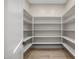 Walk-in pantry with ample shelving and neutral tones for storage convenience at 4115 E Windsor Ave, Phoenix, AZ 85008