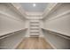 Bright walk-in closet featuring custom shelving and wooden rods for optimal organization at 4115 E Windsor Ave, Phoenix, AZ 85008