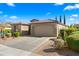 Charming single-story home with a spacious driveway, desert landscaping, and a tile roof under a blue sky at 4459 E Donato Dr, Gilbert, AZ 85298