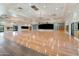 Elegant ballroom with hardwood floors, chandeliers, and a stage for special events and gatherings at 4674 E Alfalfa Dr, Gilbert, AZ 85298
