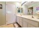 Bathroom with double sink vanity, white cabinets, and neutral color palette at 4674 E Alfalfa Dr, Gilbert, AZ 85298