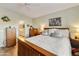 Comfortable bedroom with wood flooring, neutral décor, and a view to the ensuite at 4674 E Alfalfa Dr, Gilbert, AZ 85298