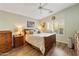 Cozy bedroom with wood floors, ceiling fan, and matching dressers at 4674 E Alfalfa Dr, Gilbert, AZ 85298