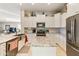 Open-concept kitchen with granite countertops, stainless steel appliances, and island seating at 4674 E Alfalfa Dr, Gilbert, AZ 85298