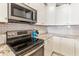 Close-up of the kitchen, featuring stainless steel appliances and white subway tile backsplash at 4674 E Alfalfa Dr, Gilbert, AZ 85298