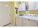 Bright laundry room with Maytag washer and dryer and overhead storage at 4674 E Alfalfa Dr, Gilbert, AZ 85298