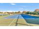 Well-maintained tennis court with a view of surrounding trees and clear sky at 4674 E Alfalfa Dr, Gilbert, AZ 85298