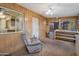 Bonus room featuring wood paneling and a comfortable recliner at 4720 E Elena Ave, Mesa, AZ 85206