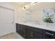 Stylish bathroom boasts a double sink vanity with dark wood cabinets and a large mirror at 4803 N Woodmere Fairway -- # 3009, Scottsdale, AZ 85251