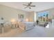 Serene bedroom with a plush bed, ceiling fan, and natural light from the large window at 4803 N Woodmere Fairway -- # 3009, Scottsdale, AZ 85251
