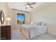 Inviting bedroom with a plush bed, neutral decor, and a large window letting in natural light at 4803 N Woodmere Fairway -- # 3009, Scottsdale, AZ 85251