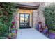 Inviting building entrance with stone accents and vibrant landscaping at 4803 N Woodmere Fairway -- # 3009, Scottsdale, AZ 85251