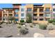 Beautiful condo building with stone accents, private balconies, and desert landscaping at 4803 N Woodmere Fairway -- # 3009, Scottsdale, AZ 85251