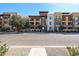 A multi-story building with a mix of stone and siding with balconies along the front at 4803 N Woodmere Fairway -- # 3009, Scottsdale, AZ 85251