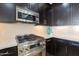 A full stainless steel appliance package with a gas range and upgraded granite countertops at 4803 N Woodmere Fairway -- # 3009, Scottsdale, AZ 85251