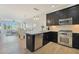 Kitchen with stainless steel appliances and a breakfast bar overlooking the dining area and living area at 4803 N Woodmere Fairway -- # 3009, Scottsdale, AZ 85251