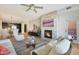 Open-concept living room with fireplace, comfortable seating, and views of the dining area and kitchen at 4803 N Woodmere Fairway -- # 3009, Scottsdale, AZ 85251