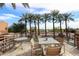 Relaxing outdoor patio with comfortable seating overlooking lush scenery and tall palm trees in a calming environment at 4803 N Woodmere Fairway -- # 3009, Scottsdale, AZ 85251