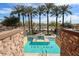 Lush pool area features relaxing landscaping and serene waterfront views from elevated stone viewing area at 4803 N Woodmere Fairway -- # 3009, Scottsdale, AZ 85251