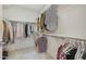Organized walk-in closet with shelving, and hanging rods providing ample storage space at 4803 N Woodmere Fairway -- # 3009, Scottsdale, AZ 85251