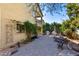 Paver patio with outdoor kitchen, seating, and lush greenery creating a private oasis at 5234 E Carol Ave, Mesa, AZ 85206